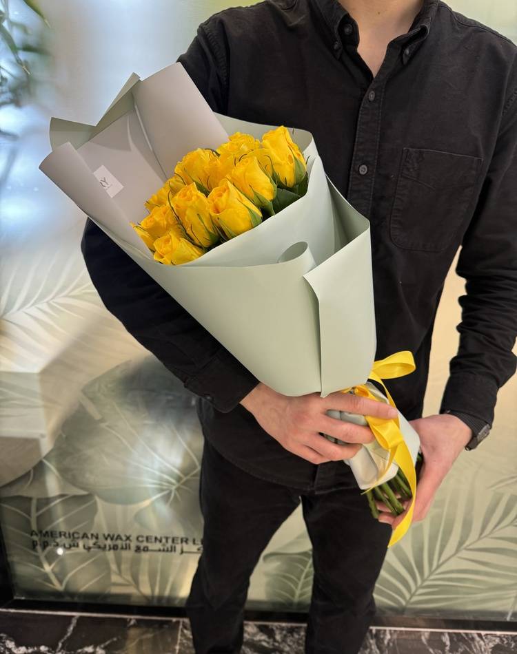 bouquet of 15 yellow roses in a packaging